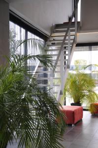 a living room with a red couch and plants at Hotel Corbie Lommel in Lommel