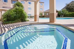 a swimming pool in front of a building at Staybridge Suites San Angelo by IHG in San Angelo