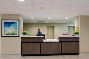 a man sitting at a desk in an office at Candlewood Suites Richmond - West Broad, an IHG Hotel in Richmond