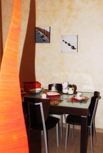 a table and chairs in a room with a table at Le Sorelle in Lecce