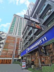 a tall building with a store in front of it at Citin Sukhumvit 11 Nana Bangkok by Compass Hospitality in Bangkok