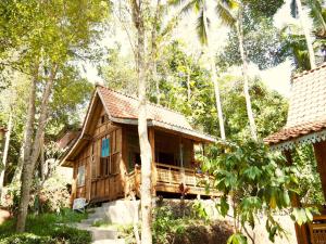 a wooden house in the middle of trees at Green Vanilla Bungalow in Sidemen