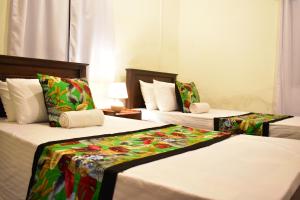 מיטה או מיטות בחדר ב-Arachiwil Green Nature Resort