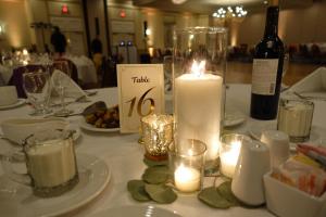 a table with a candle and a bottle of wine at Holiday Inn Portland-By the Bay, an IHG Hotel in Portland