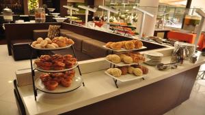 a bakery with three tiers of pastries on a counter at Holiday Inn Tijuana Zona Rio, an IHG Hotel in Tijuana