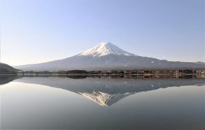 a mountain reflecting on the water of a lake at Erable Mt.Fuji "Zen" in Fujikawaguchiko