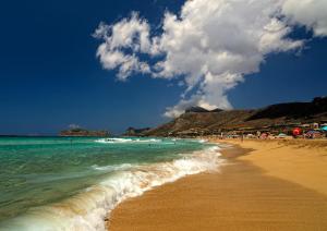 a beach with people on it and the ocean at Falasarna Bay in Falasarna