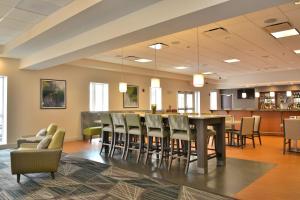 a dining room with a table and chairs at Holiday Inn Hotel & Suites Rochester - Marketplace by IHG in Rochester