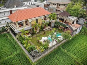 an aerial view of a house with a swimming pool at Nang Ade Villa by Pramana Villas in Ubud