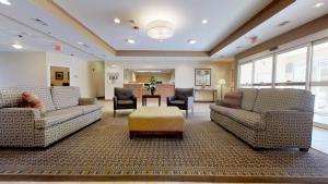 a large living room with couches and a table at Candlewood Suites Slidell Northshore, an IHG Hotel in Slidell