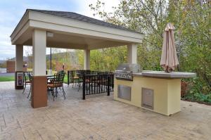 a pavilion with a grill and a table and chairs at Candlewood Suites Sayre, an IHG Hotel in Sayre
