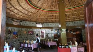 a person sitting at a table in a restaurant at Jerusalem Hotel Lalibela in Lalibela +79 photos