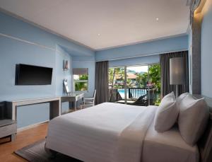 a bedroom with a large bed and a large window at Aonang Villa Resort - SHA Extra Plus in Ao Nang Beach