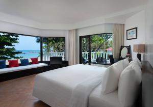 
a hotel room with two beds and a large window at Aonang Villa Resort - SHA Extra Plus in Ao Nang Beach
