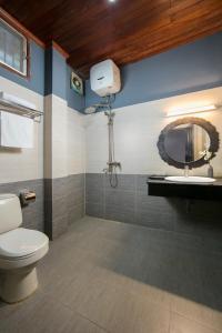 a bathroom with a toilet and a sink and a mirror at Vientiane Boutique Hotel in Vientiane