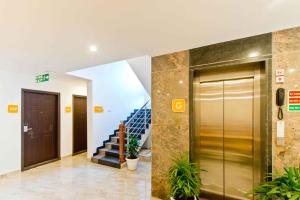 an elevator in a building with a staircase at X by Bloom I Hebbal Manyata Park in Bangalore