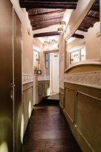 a hallway with a door and a room with wooden floors at Locanda Del Sole-Roma in Rome