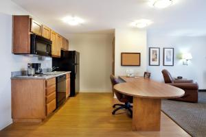 a kitchen and dining room with a table in a room at Candlewood Suites Lake Charles-Sulphur, an IHG Hotel in Sulphur
