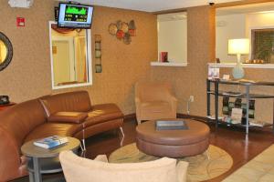 a living room with a couch and a tv at Candlewood Suites Syracuse-Airport, an IHG Hotel in North Syracuse