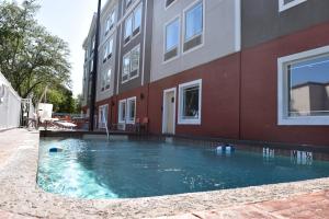 a swimming pool in front of a building at Holiday Inn Express Venice, an IHG Hotel in Venice