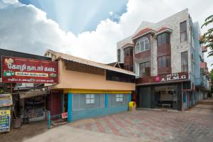 an empty street in a town with buildings at Hotel AKMG in Dindigul