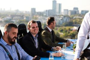 a group of men sitting at a table with drinks at Complex Silva in Bucharest