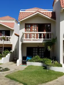 a large white house with a balcony at Nanny Estates Cabarete kiters Condo C-6 in Cabarete