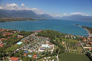 an aerial view of a city and a body of water at Camping Baia Verde in Manerba del Garda