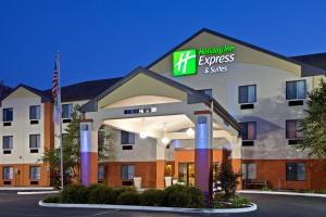 a hotel room with a sign for the holiday inn express suites at Holiday Inn Express & Suites - Muncie, an IHG Hotel in Muncie