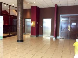 a lobby with two doors and a tile floor at Holiday Inn Barnsley, an IHG Hotel in Barnsley