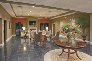 a lobby with a waiting room with a table and chairs at Holiday Inn Carbondale - Conference Center, an IHG Hotel in Carbondale