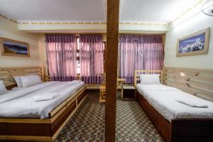 Postel nebo postele na pokoji v ubytování Hotel Pomelo House Inn