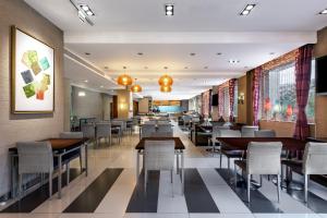 a dining room with tables and chairs in a restaurant at Holiday Inn Express Shangdi Beijing, an IHG Hotel in Beijing