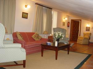 a living room with a couch and a coffee table at Hostal Rural Cumbres De Castilla in Mandayona