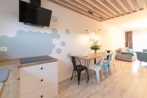 a kitchen and dining room with a table and chairs at Apartament Pod Czantorią z tarasem - Dream Apart in Ustroń