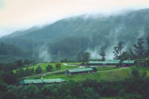 a farm in the middle of a mountain at Destiny - The Farm Resort in Ooty