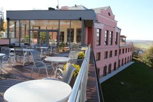 a balcony with tables and chairs on a building at Hotel Cvilín in Krnov