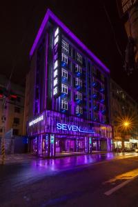 a lit up building with purple lights on a street at Seven Fukun Hotel in Jiaoxi