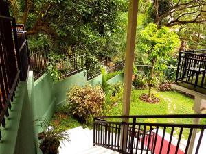 a view of a garden from the balcony of a house at Jaye's Homestay in Kandy