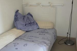 a bed with a pillow with a sail on it at Anglet plage T2 vue parc Atlantide in Anglet