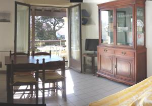 a dining room with a table and chairs and a cabinet at Anglet plage T2 vue parc Atlantide in Anglet