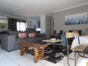 a living room with a couch and a table at 80 on Benade in Bloemfontein