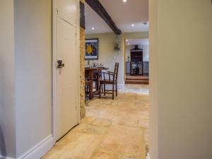 a hallway leading to a kitchen and a dining room at Archers in Winchcombe +16 photos