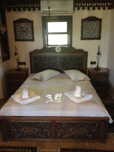 a bedroom with a bed with two towels on it at Nilya Hotel in Selçuk