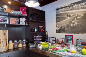 a restaurant with a counter with food on it at Enzo Hotels Reims Tinqueux in Reims