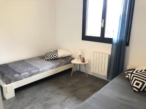 a small bedroom with a bed and a table at Angel Services - Le parc des Charmilles in Menthon-Saint-Bernard