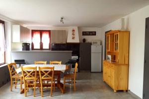 a kitchen and dining room with a table and chairs at Gîte de la Fouquetière in Pontorson