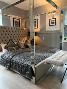 a bedroom with a bed, chair, and nightstand at Boutique Hotel Villa Sarah ehemals Villa Emilia in Düsseldorf