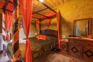 a bedroom with a canopy bed and a mirror at Ontas Guesthouse & Spa in Arachova