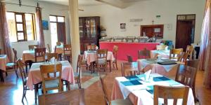 a restaurant with tables and chairs in a room at Miryams Village Inn Safari Lodge in Sultan Hamud